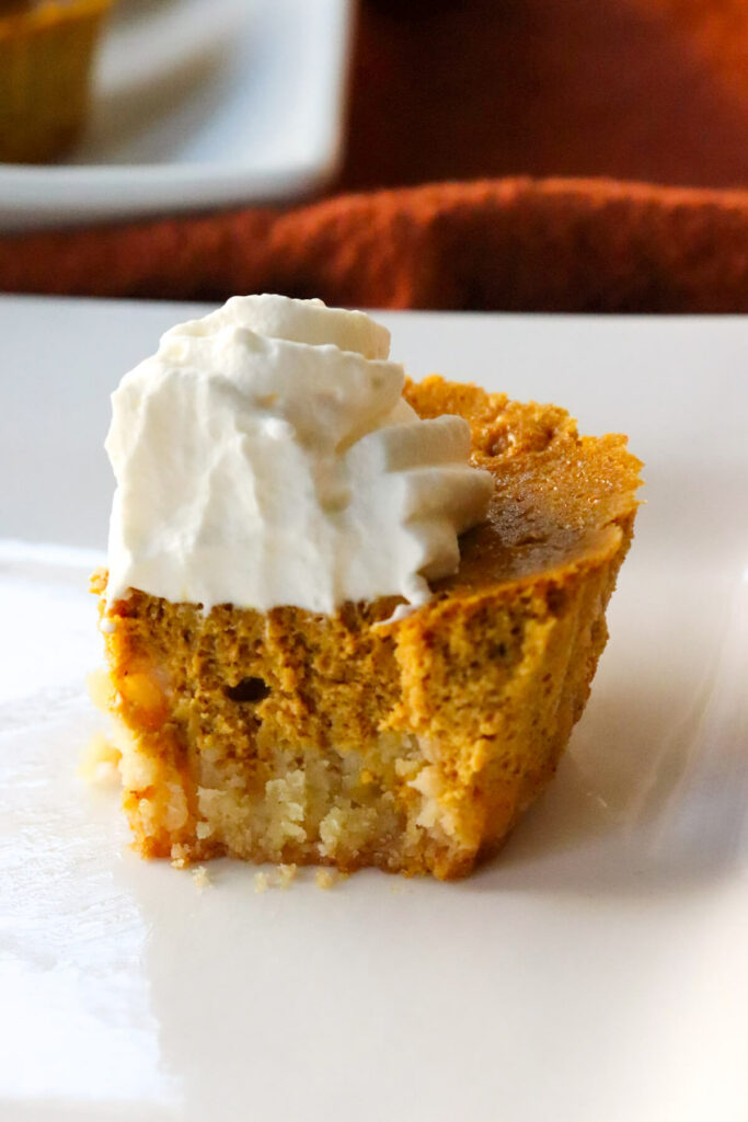 Close up of a side view of the mini keto pumpkin pie with a bite out