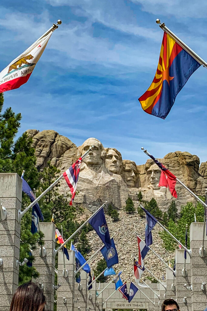 Mount Rushmore with the state flags in front