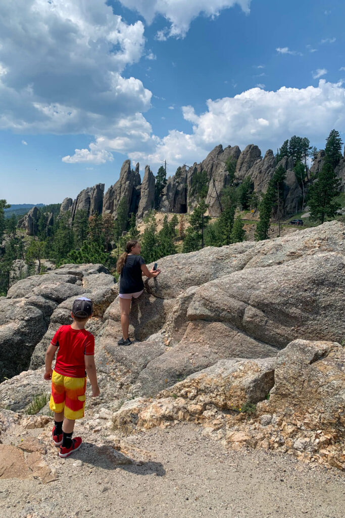 Two kids hiking around the Needles Highway stop