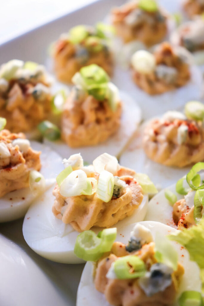 Front view of a white plate of keto deviled eggs