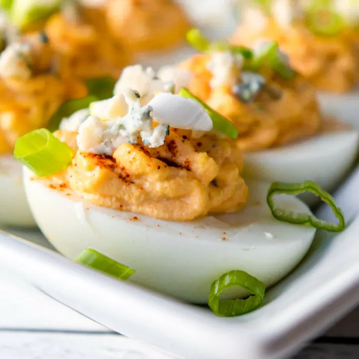 Front view of a keto Buffalo deviled egg on a white plate