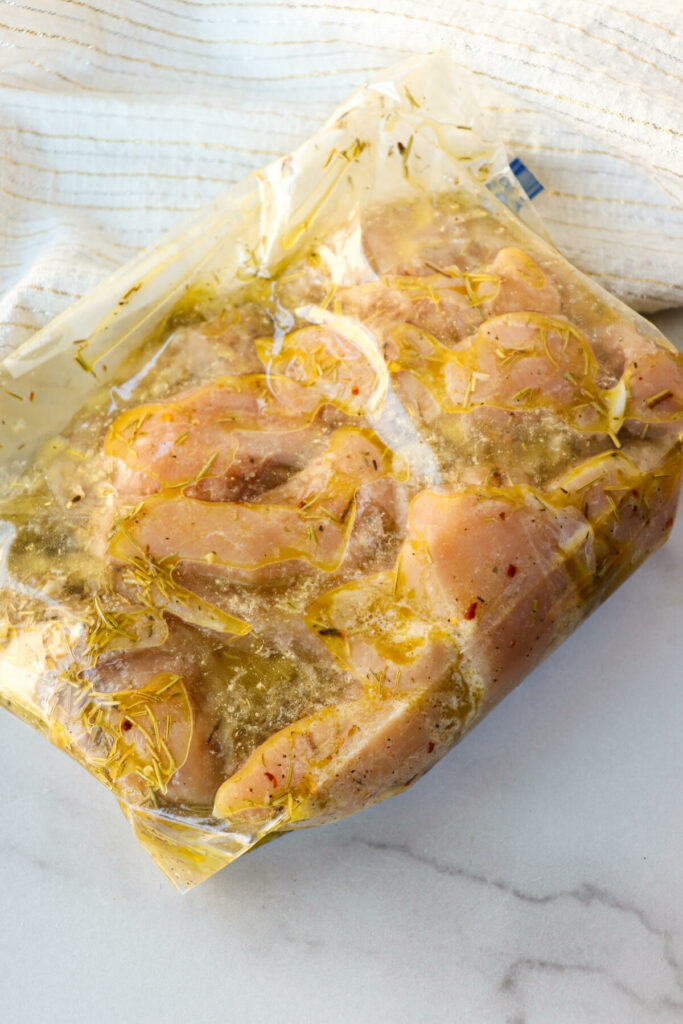 Chicken tenderloins in a zipper bag with a Greek marinade