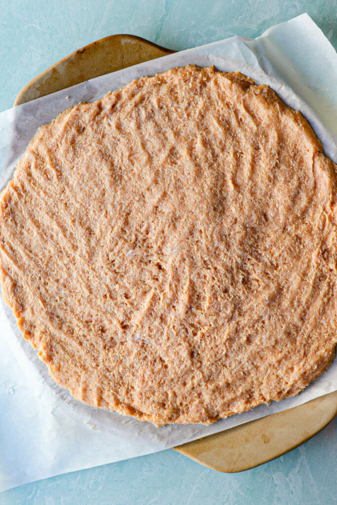 Pressed out chicken crust in a round ready to bake, overhead view