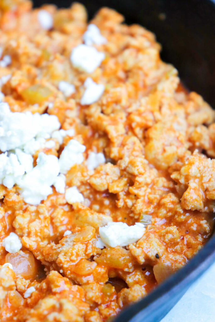 Close up view of a skillet of Buffalo chicken Sloppy Joes