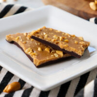 Two pieces of keto peanut butter bark on a white plate