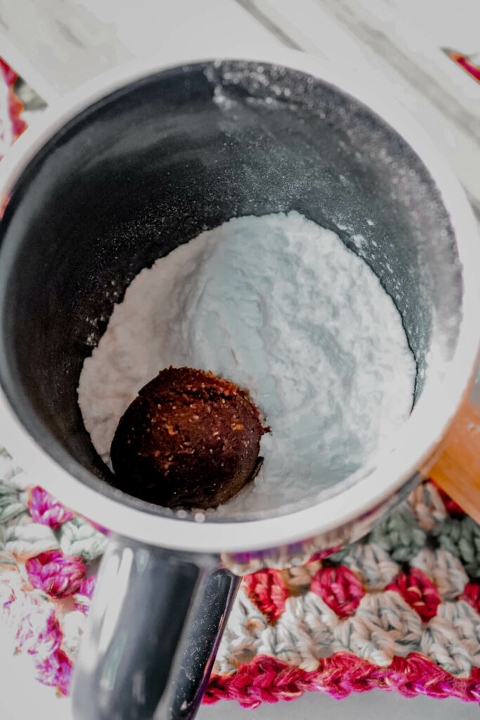 A keto crinkle cookie dough ball in the powdered sweetener
