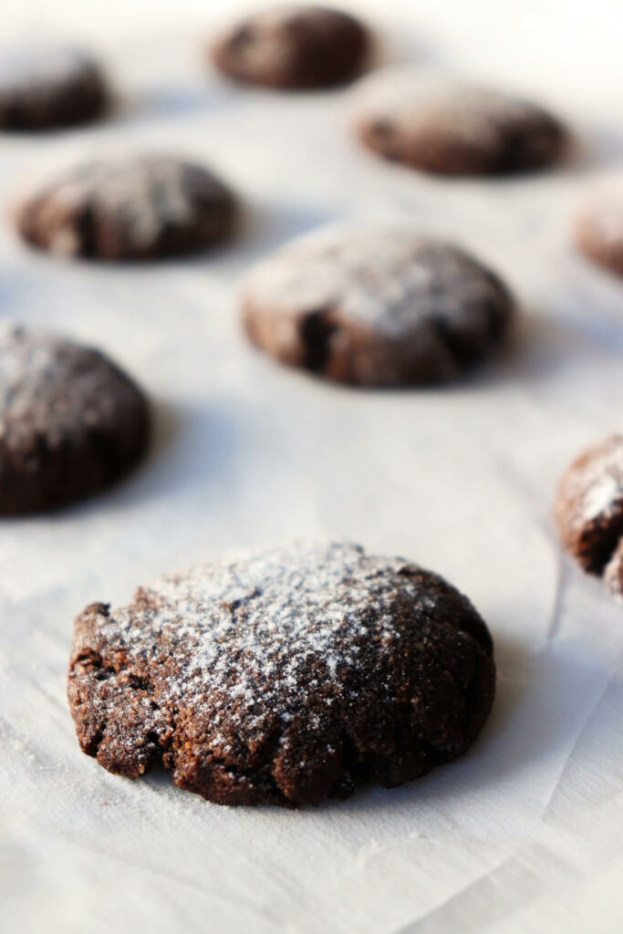 Keto Chocolate Crinkle Cookies on a piece of parchment paper