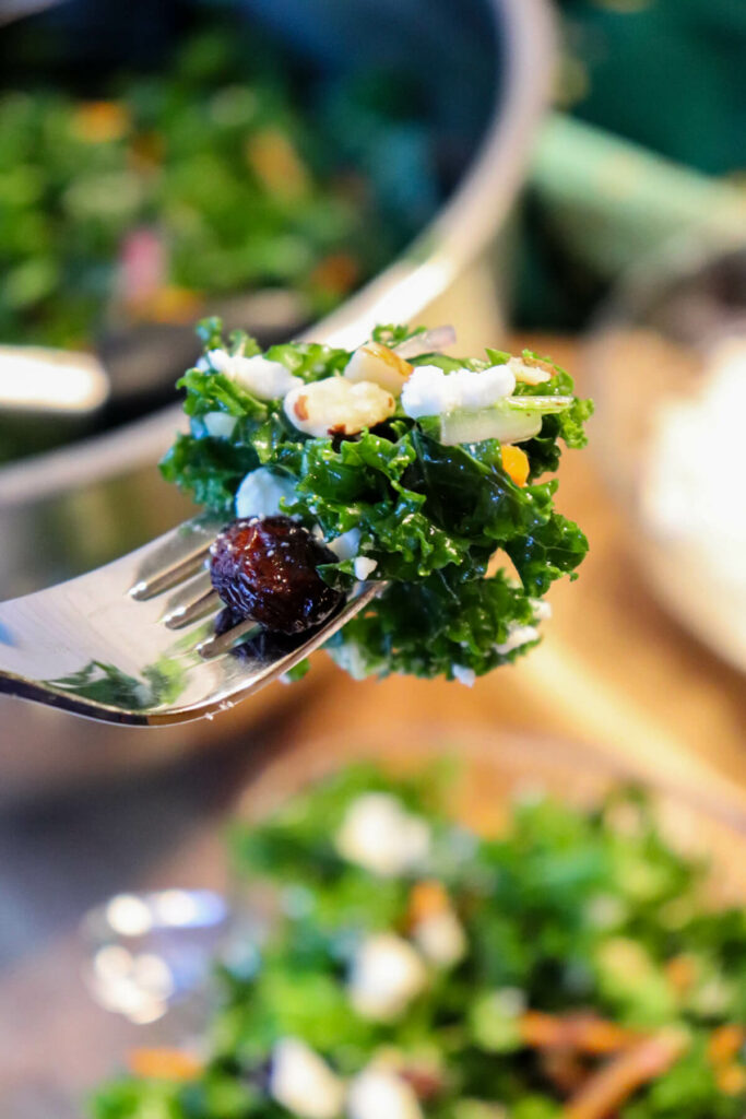 A bite of keto kale salad on a fork