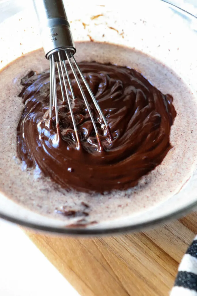 A heavy cream and melted chocolate whisking into a ganache