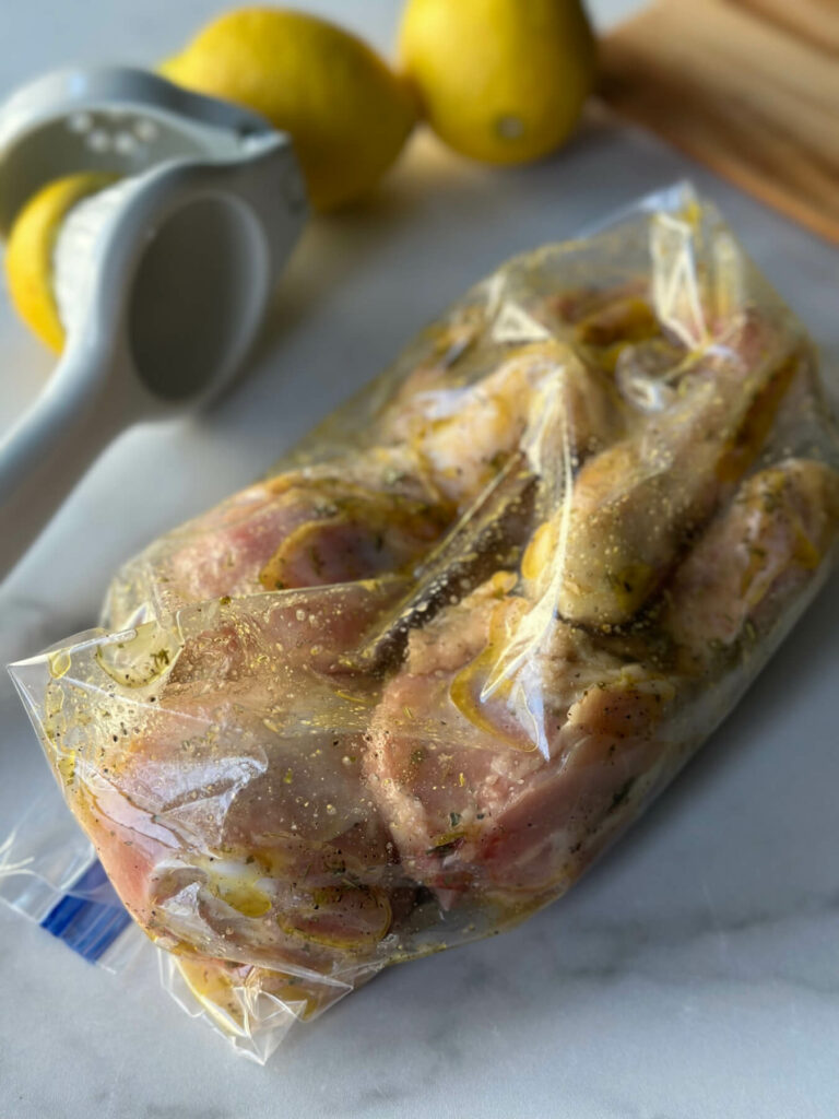 Air fryer chicken legs in a zipper bag with marinade