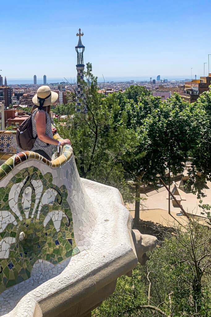 Woman looking out at Park Guell wearing a sunhat