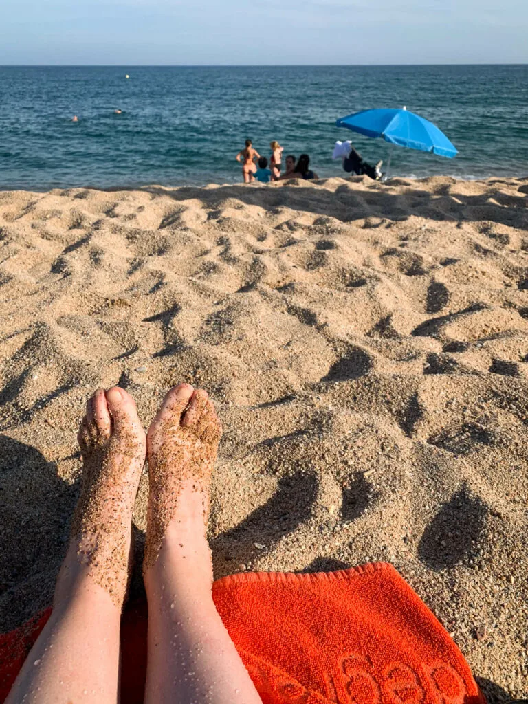 Sandy feet on the beach in Barcelona