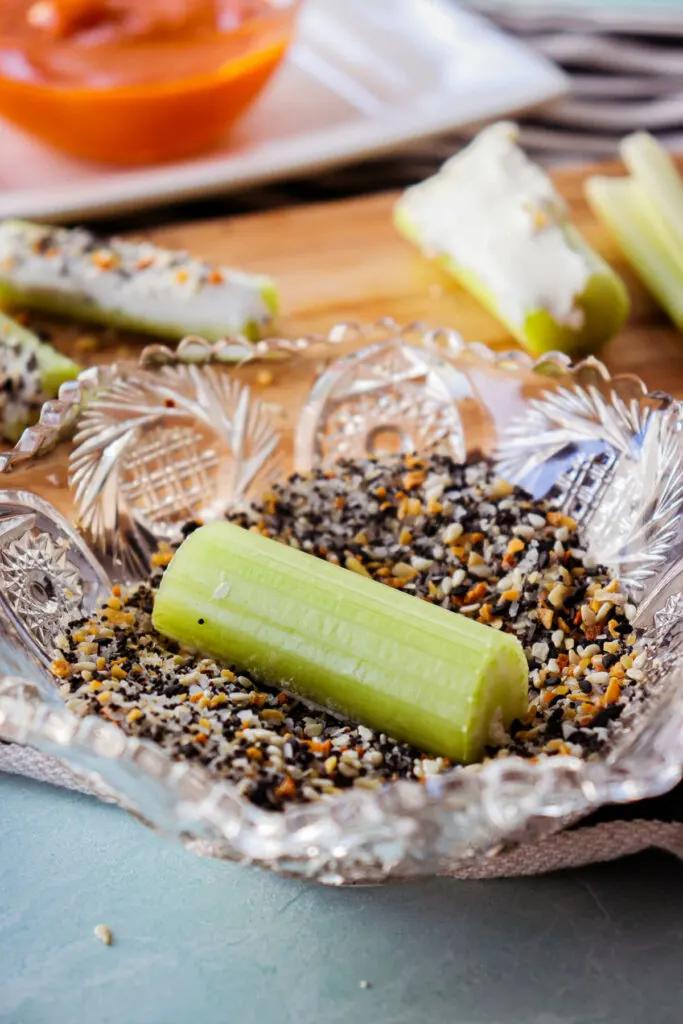 Upside down piece of celery in the everything bagel seasoning bowl