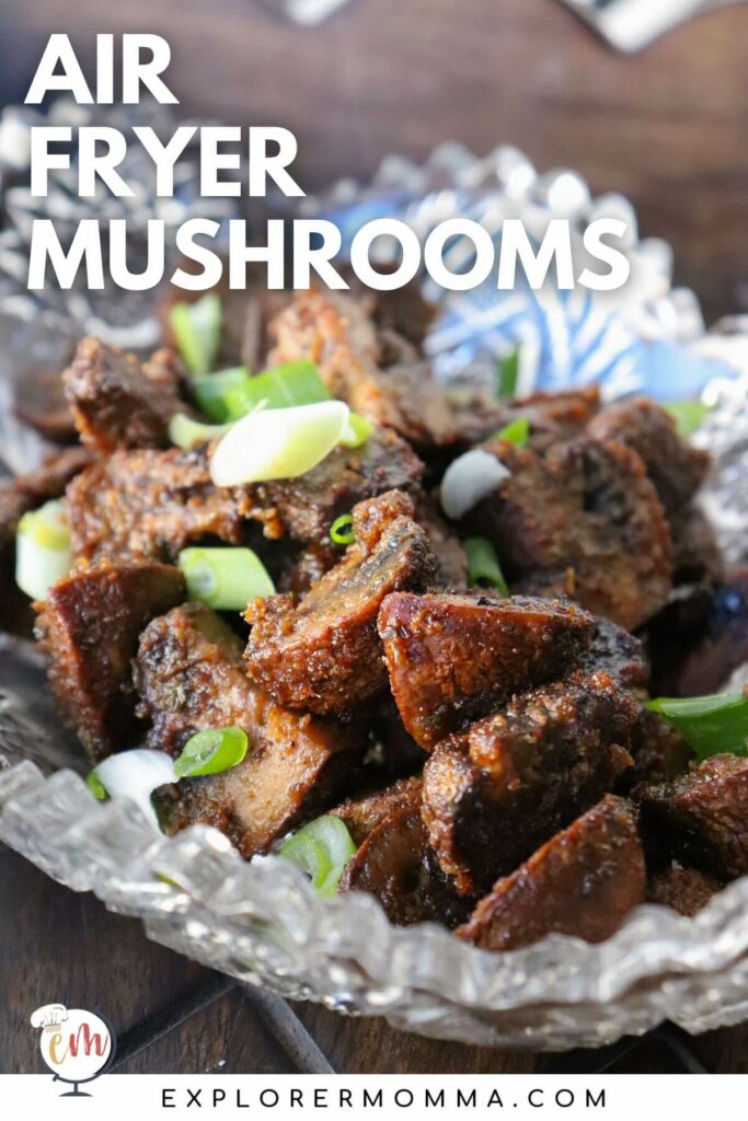 A glass bowl of air fryer mushrooms with sliced green onions.