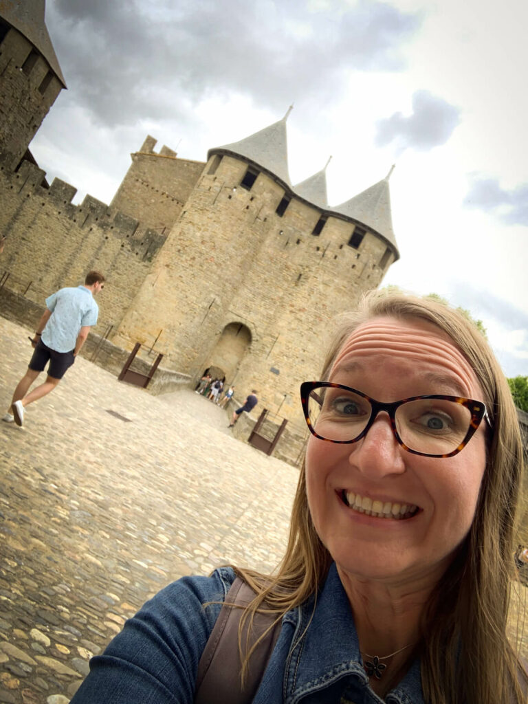 Lauren smiling in front of the castle in Carcassonne France