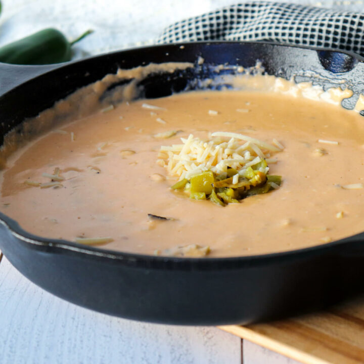 Cast iron pan full of green chile queso