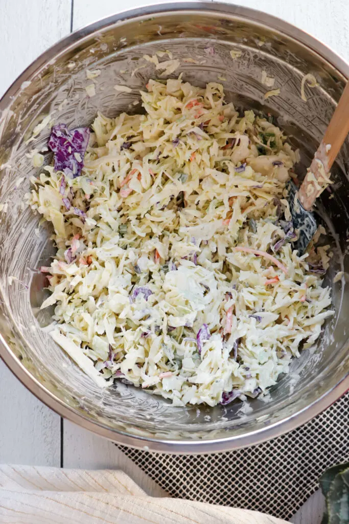 An overhead view of keto coleslaw mixed in a metal bowl