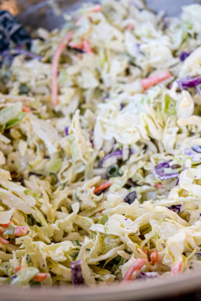 A front view of keto coleslaw mixed in a metal bowl