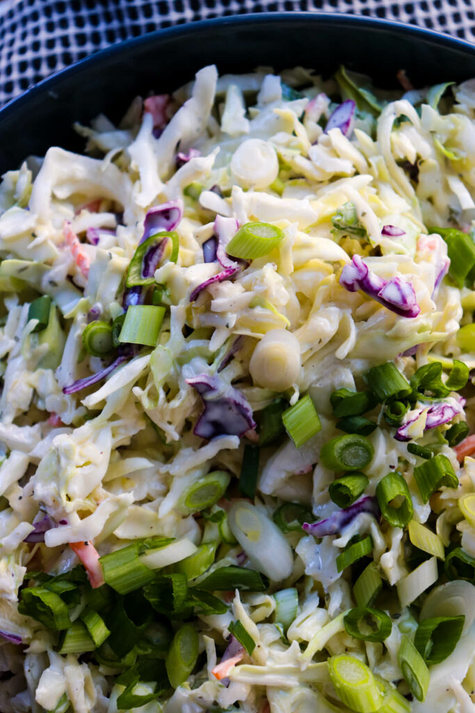 A close up view of low carb coleslaw in a blue bowl