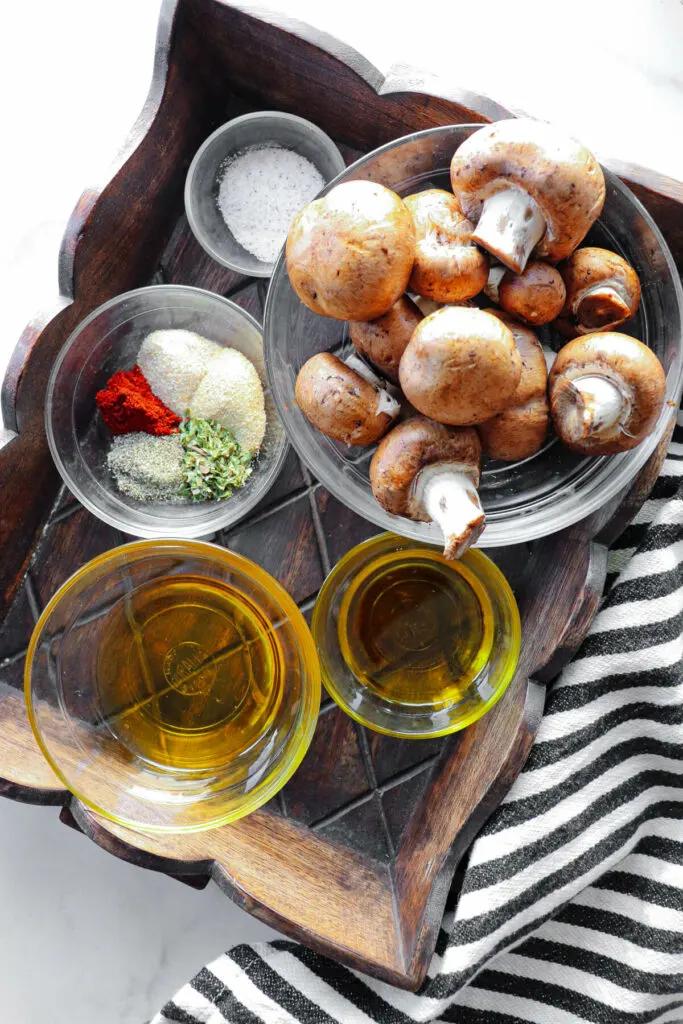 Ingredients in keto air fryer mushrooms in glass bowls, overhead view