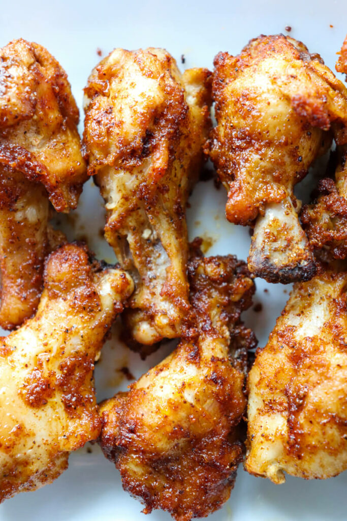 Overhead view of frozen air fryer wings on a white plate