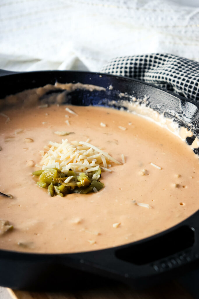 A cast iron skillet of green chile cheese dip