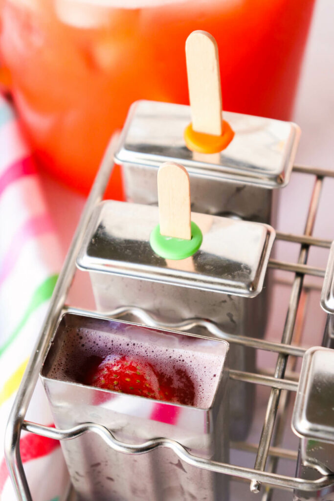Close up view of stainless steel popsicle molds with sugar free popsicle mixture