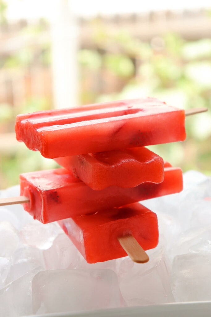 A stack of sugar free strawberry lemonade keto popsicles