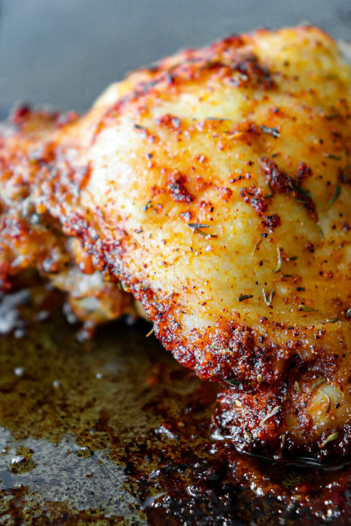 Front view of view of a keto baked chicken thigh on a baking pan
