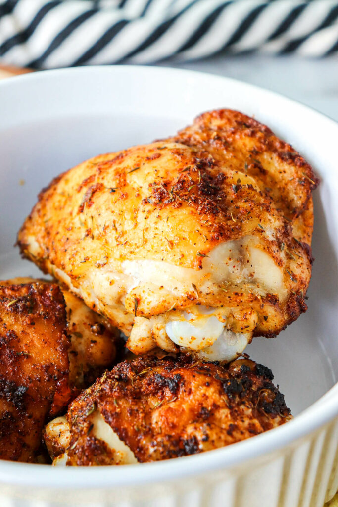 Three low carb baked chicken thighs in a white dish