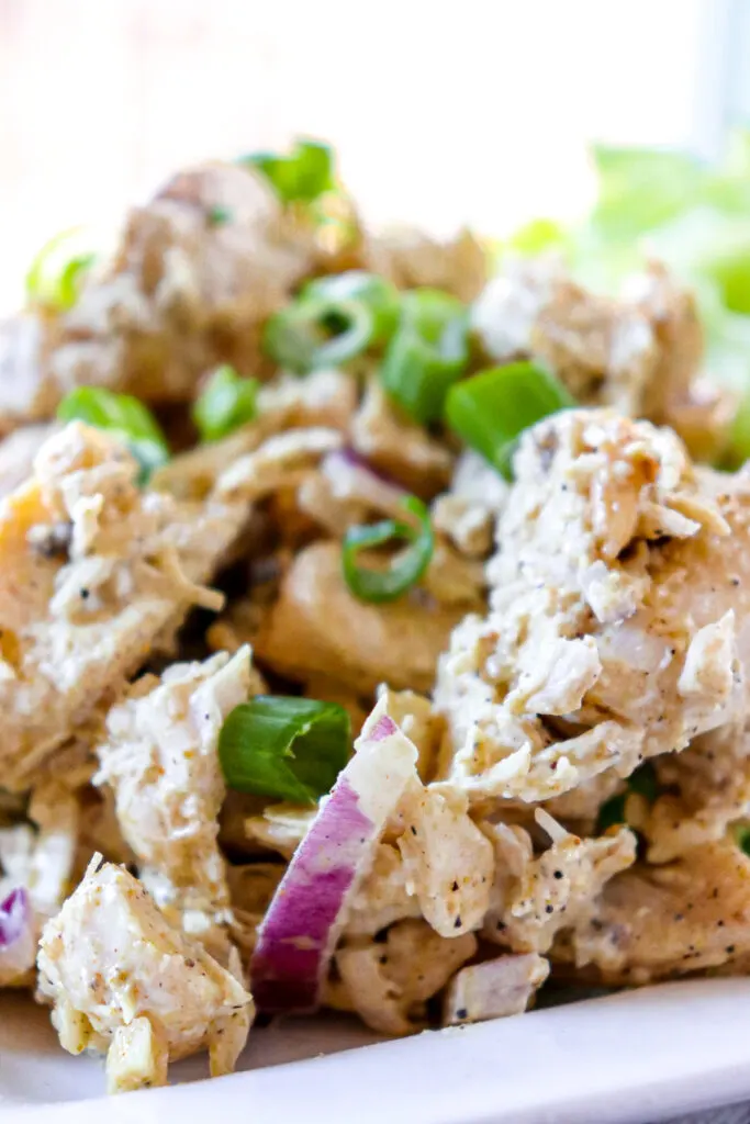 Front close up view of keto curry chicken salad on a white plate