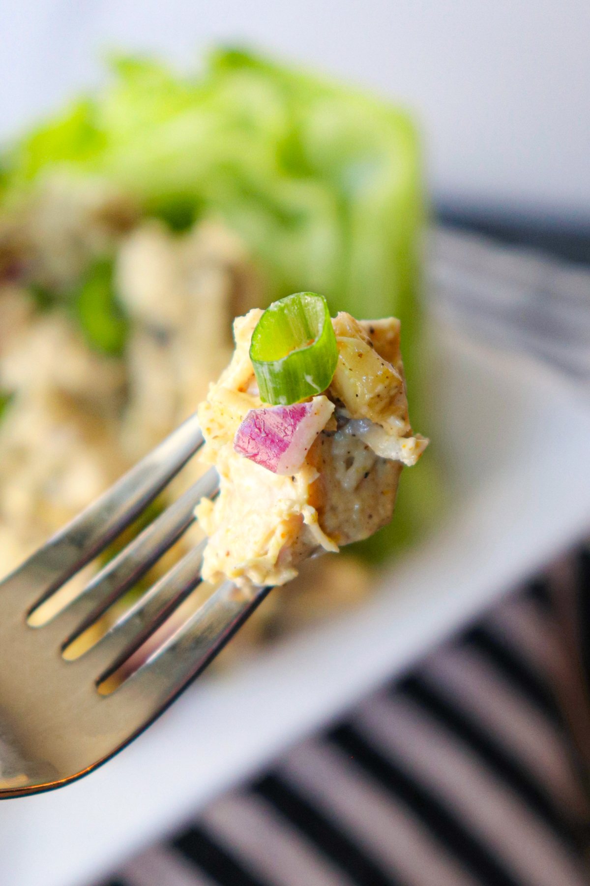 Bite of curry keto chicken salad on a fork