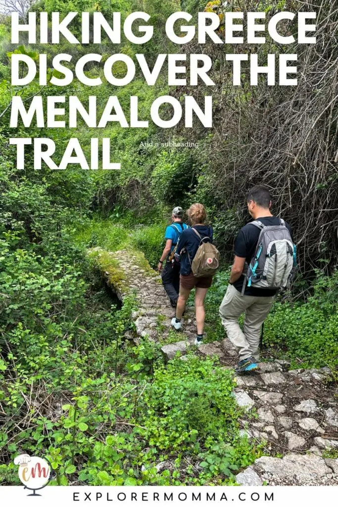 Three hikers walking on a stone path on the Menalon Trail