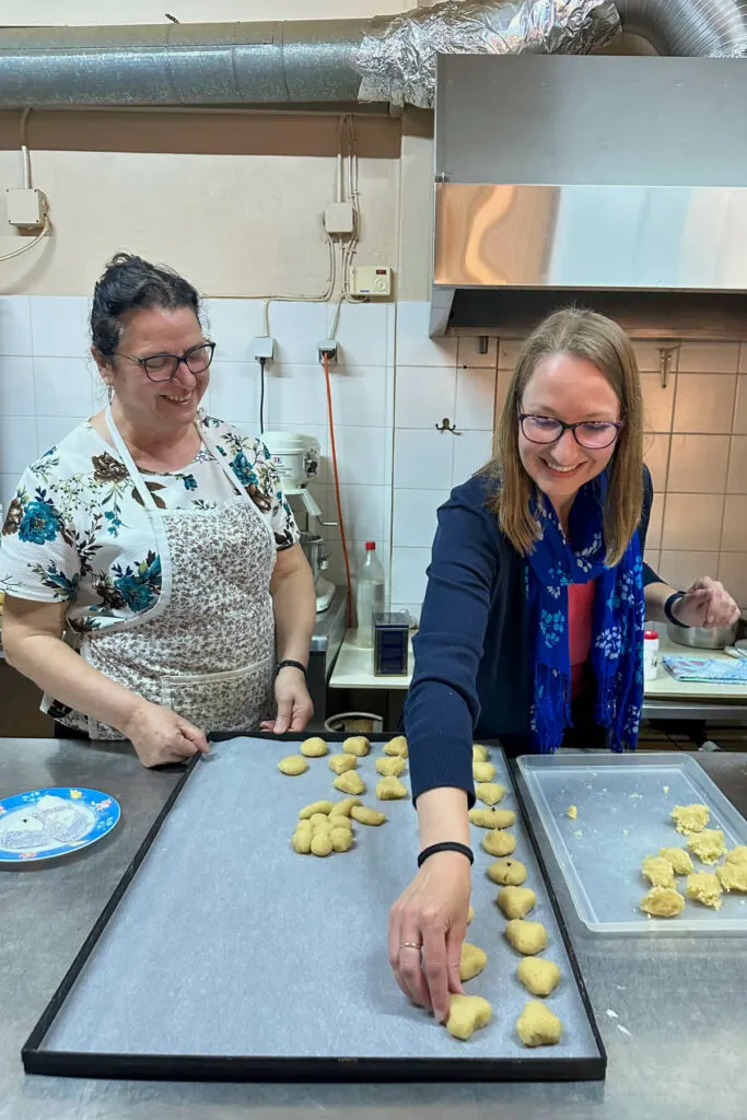 Maria helping me to make Greek almond cookies on a large sheet pan