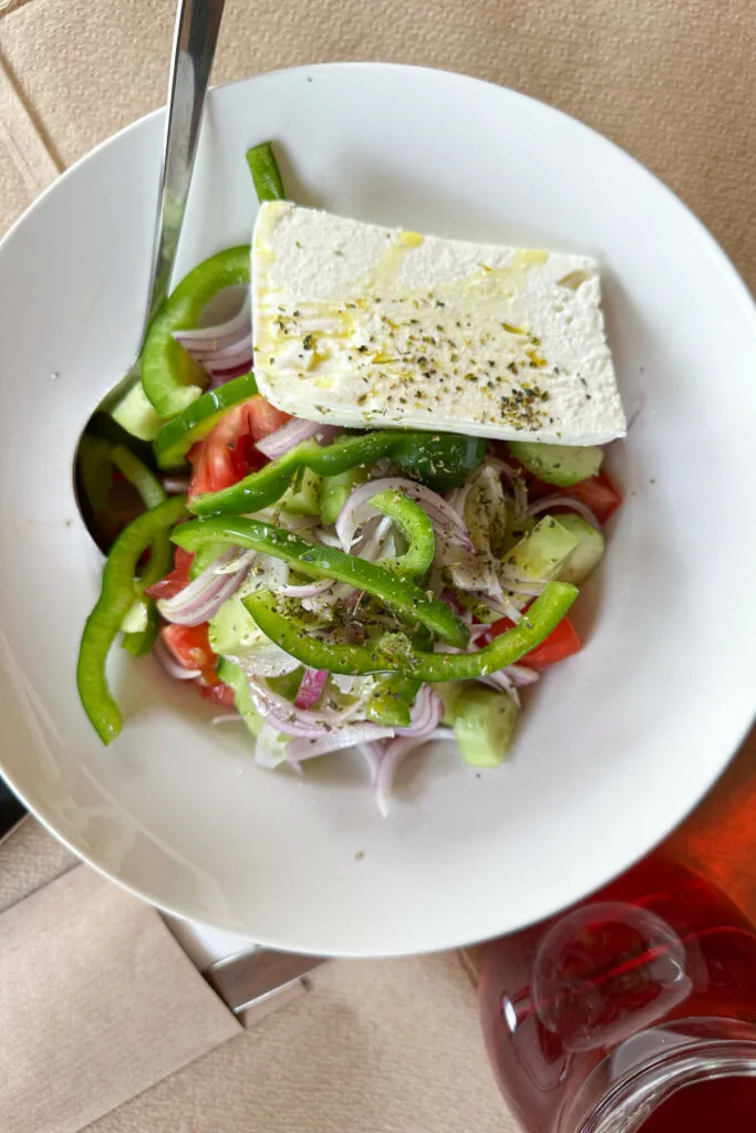 Overhead view of a Greek salad with feta cheese