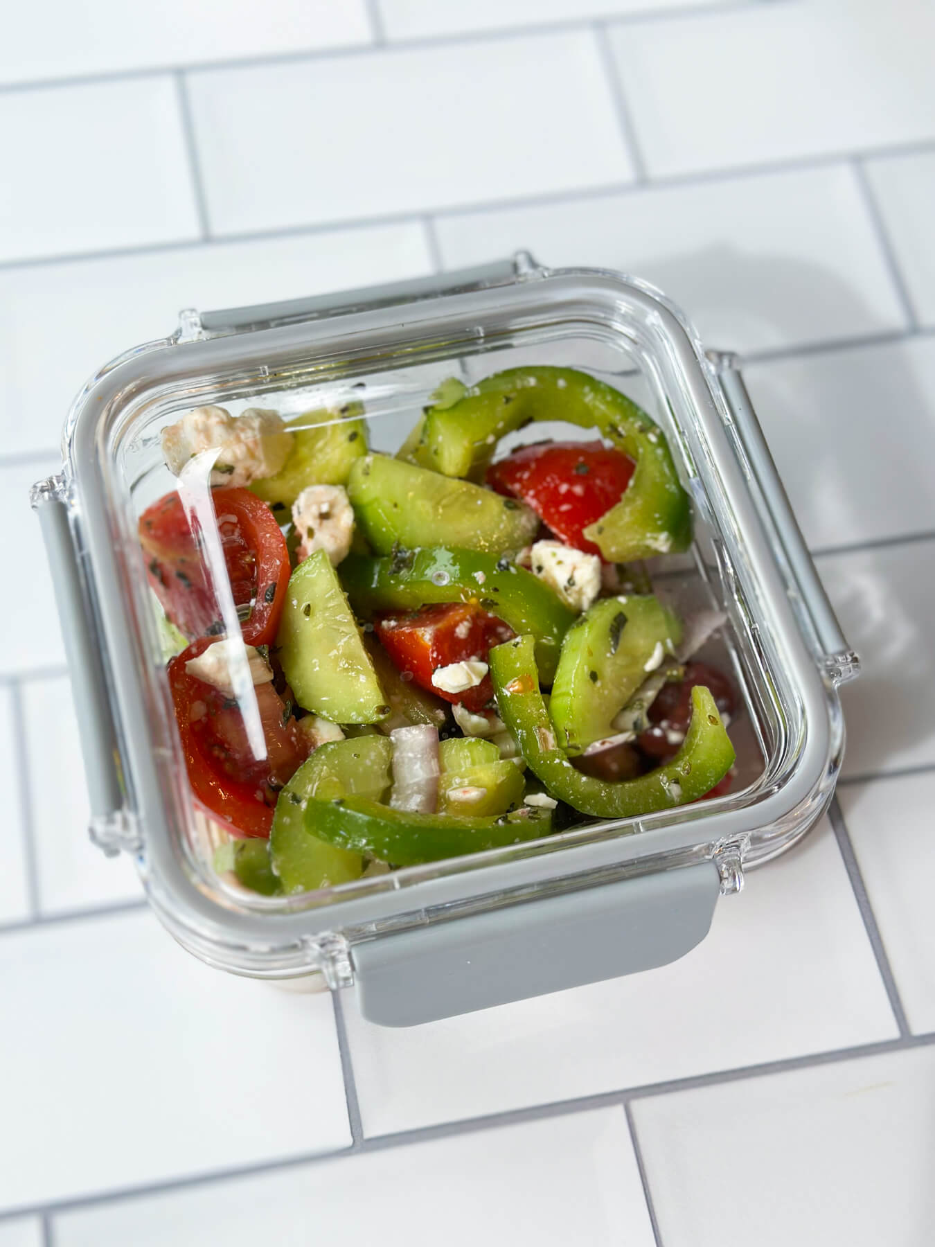 Low carb Greek cucumber salad in a storage container