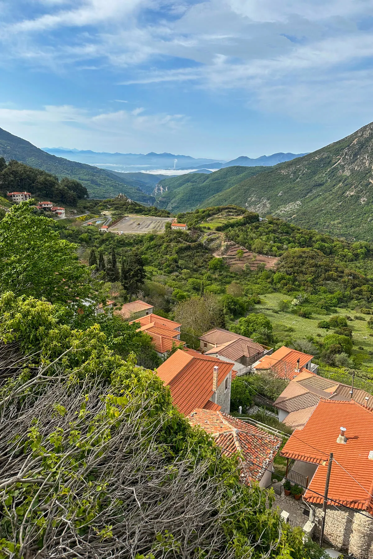 A view of the Lousios Gorge dotted with red roofs