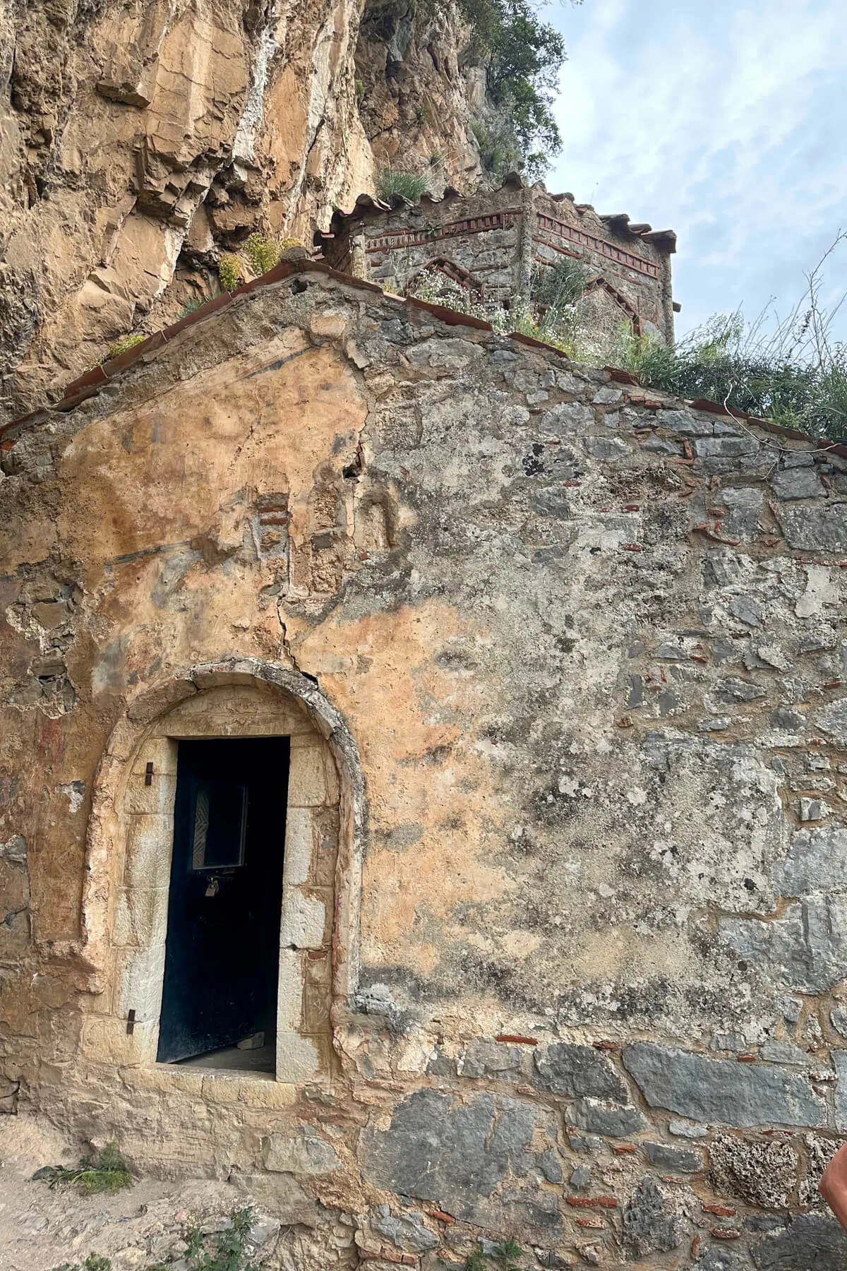 The old Philosopher's Monastery, a church built into the side of the cliff in the Lousios Gorge