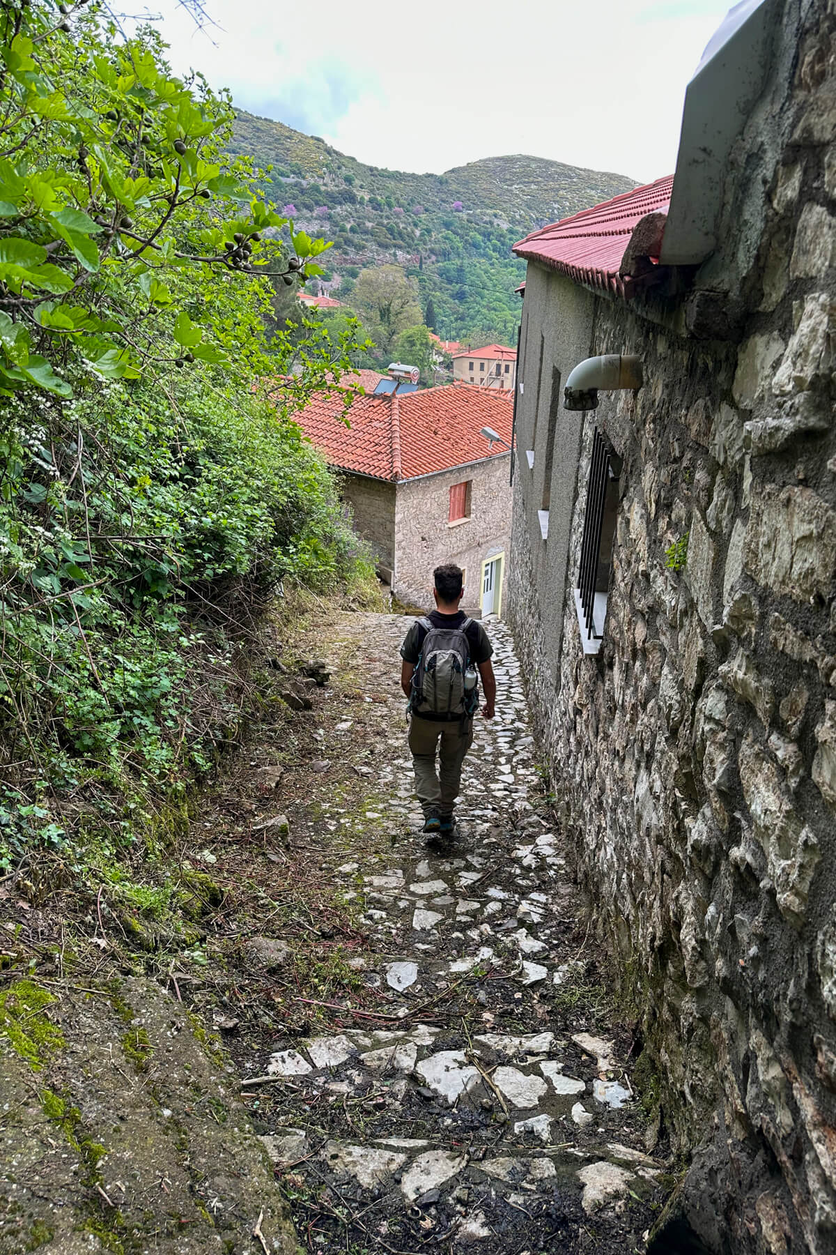 Man walking along a rock path in the village