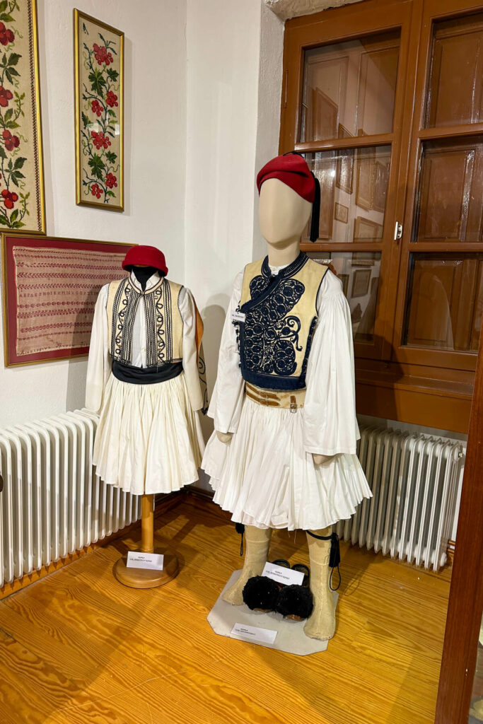 Traditional Greek costumes on 2 stands