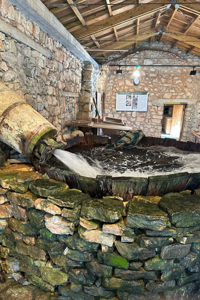 Water Power Museum, a view of the water flowing into a stone vat where they clean blankets and clothes, etc.