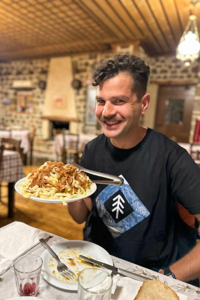 Alexandros, our tour guide, holding up a plate of Greek egg pasta and sauce