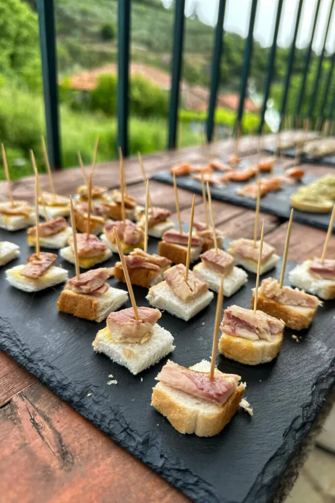 Black stone plate of fish samples with toothpicks