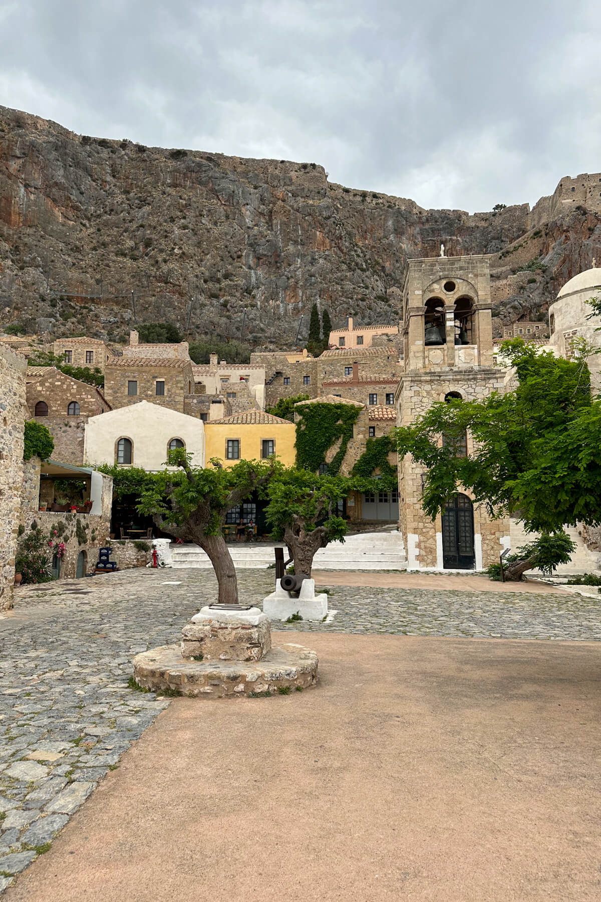 Lower town Monemvasia view with a tree at the center and several churches in the back