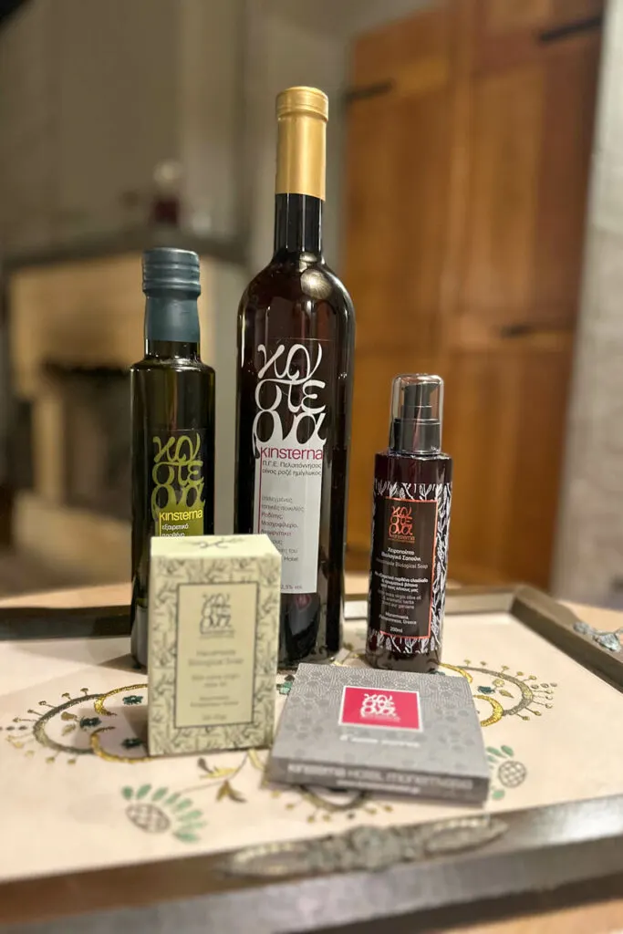 Bottles of wine, olive oil, soap, and other estate made items on a decorated table