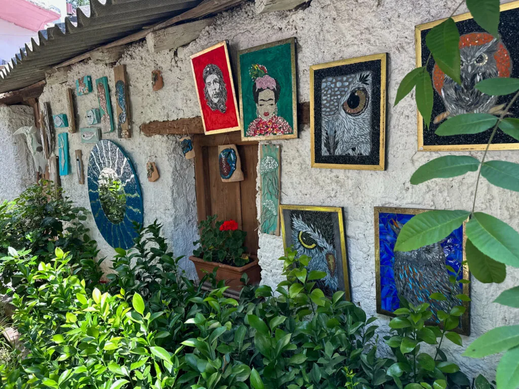 View of handmade modern mosaics hanging on the wall of a building.