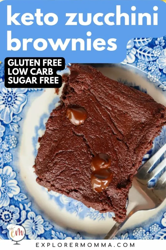 A keto zuccini brownie (low carb) on a blue and white plate with a fork next to it.