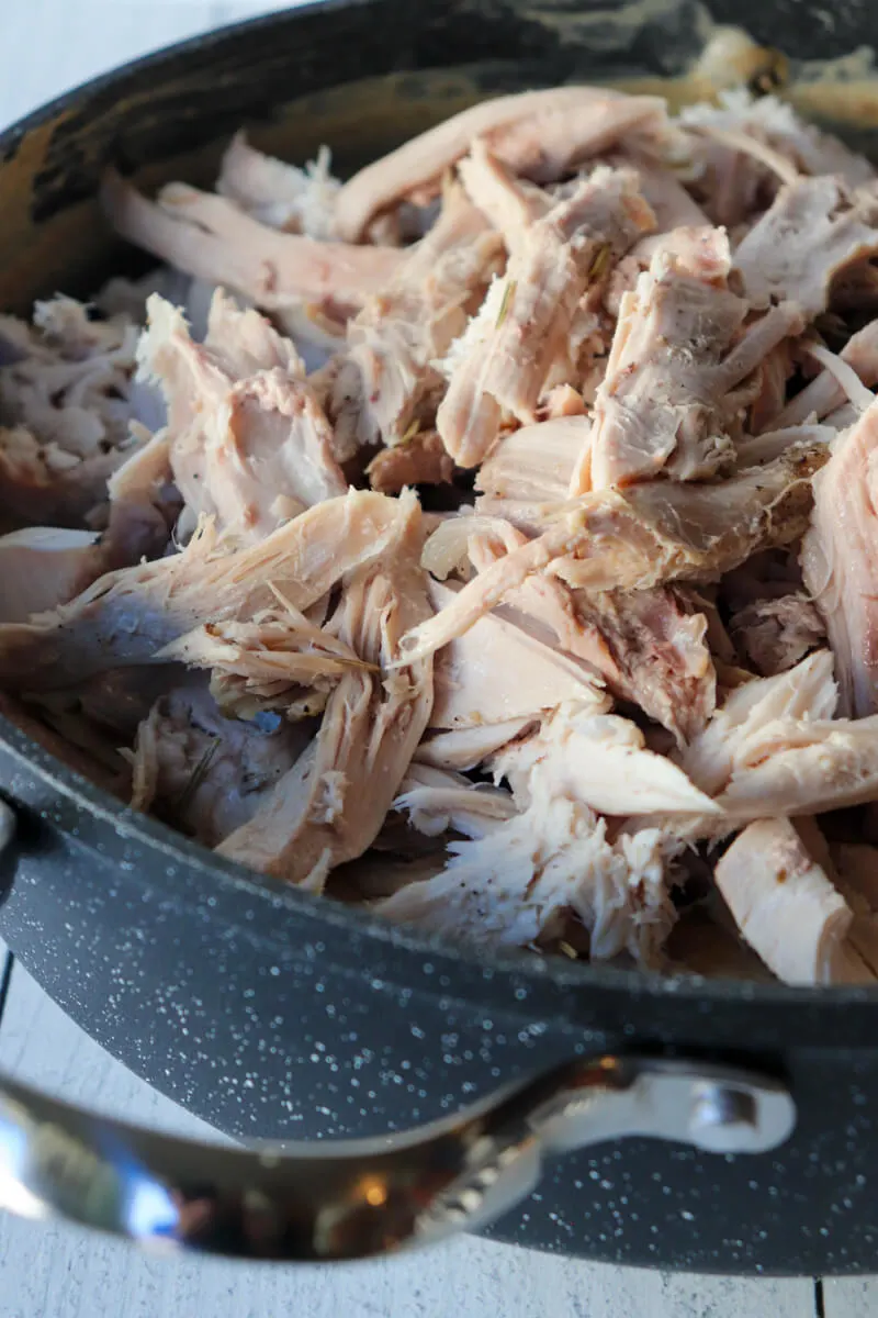 Shredded turkey in a skillet.