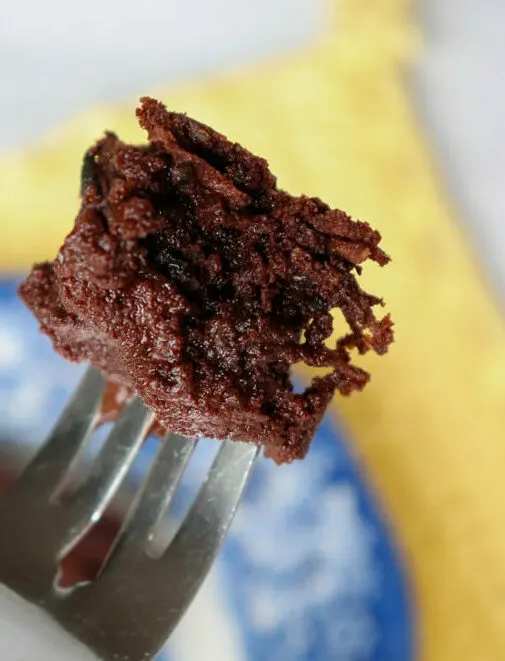 One bite of a low carb zucchini brownie on a fork.