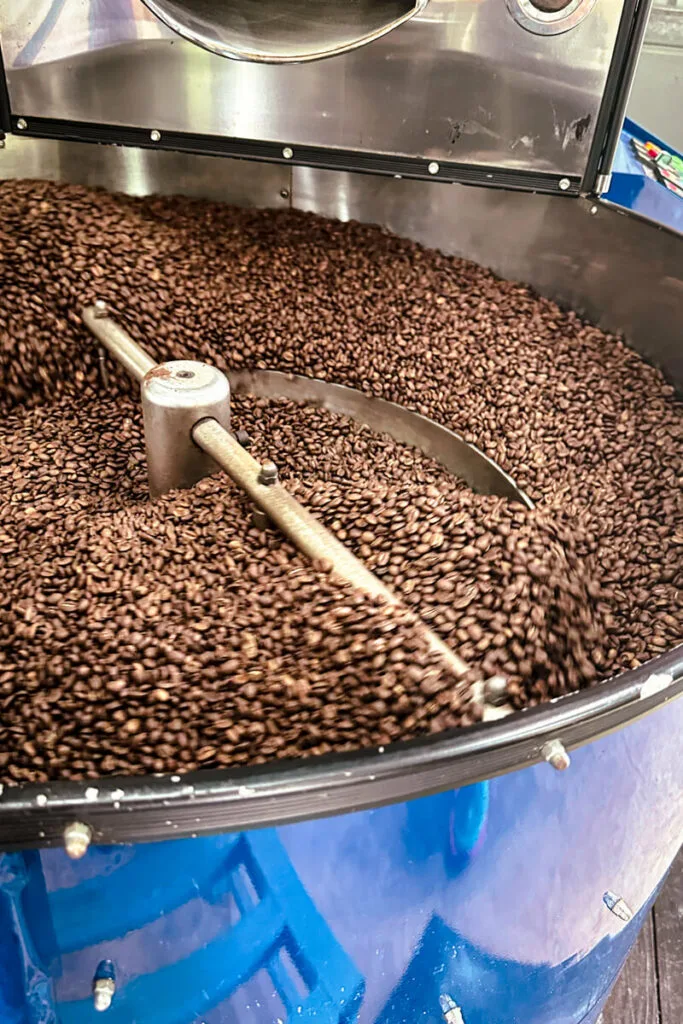 A large vat of roasted coffee beans